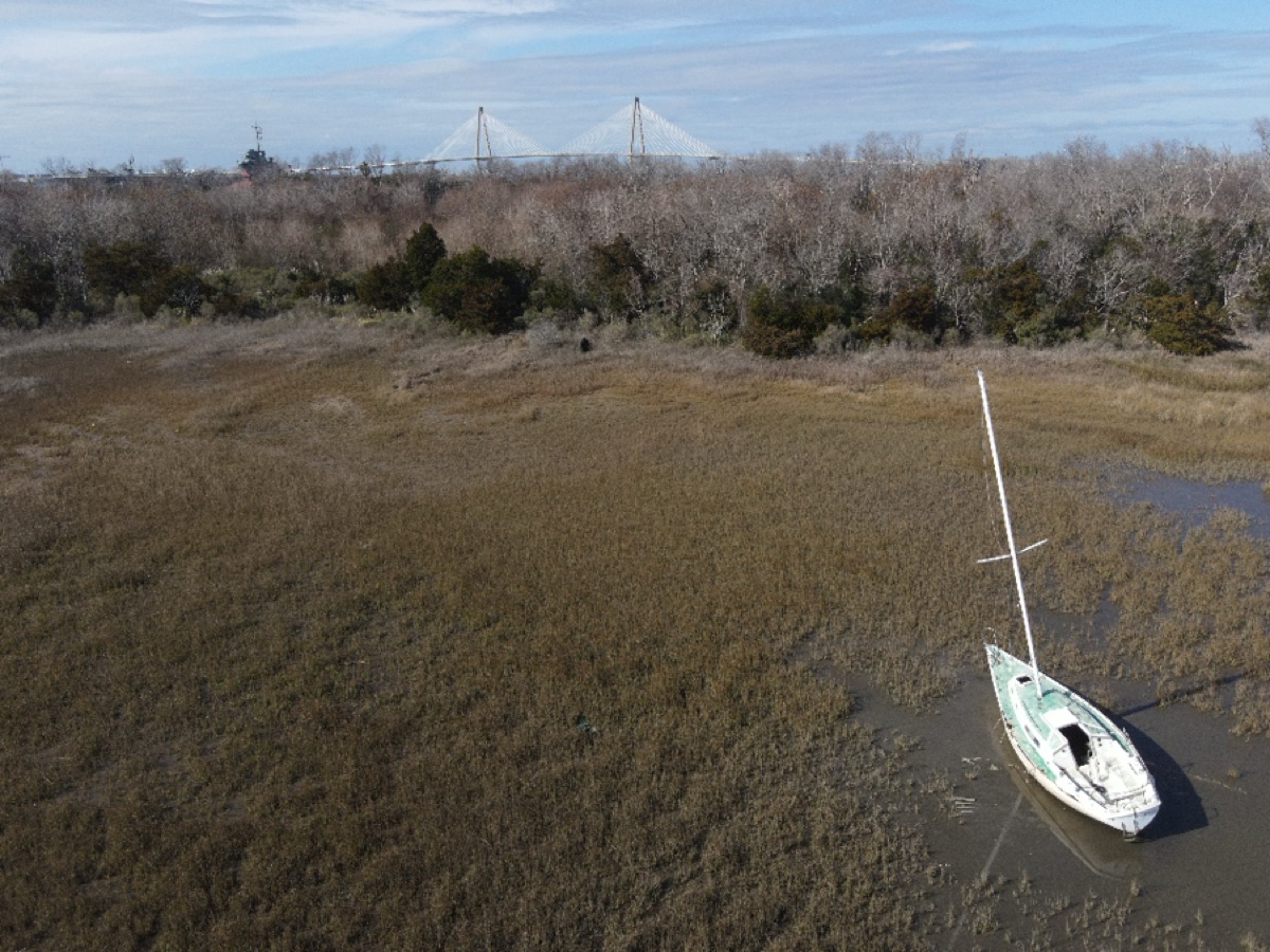 Drone view of a small sailboat in marsh water near Charleston, South Carolina