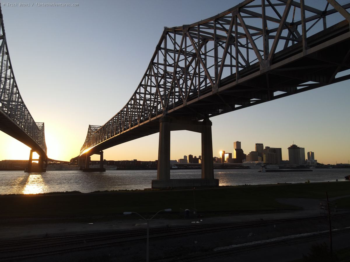 Twin cantilever bridges of the Crescent City Connection spanning the Mississippi River at sunset with the downtown New Orleans skyline, Louisiana