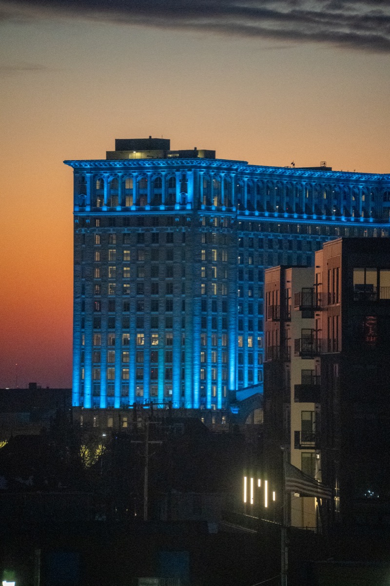 Michigan Central Station in Corktown, Detroit lit blue at dusk