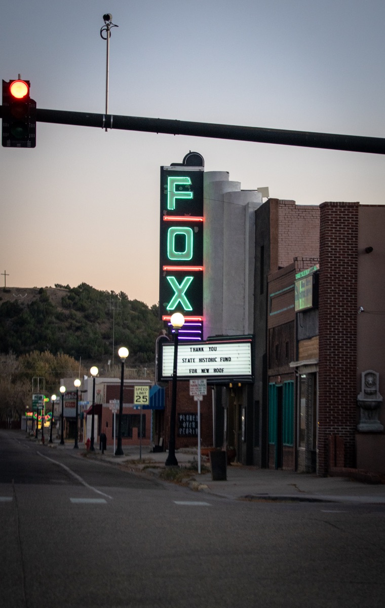 The Fox Theatre marquee glowing at dusk on a street in Joplin, Missouri
