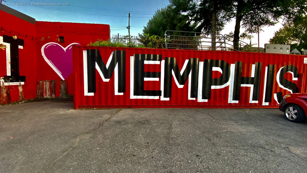 I Love Memphis mural painted in black and white letters across a red shipping container beside a red wall, Memphis, Tennessee
