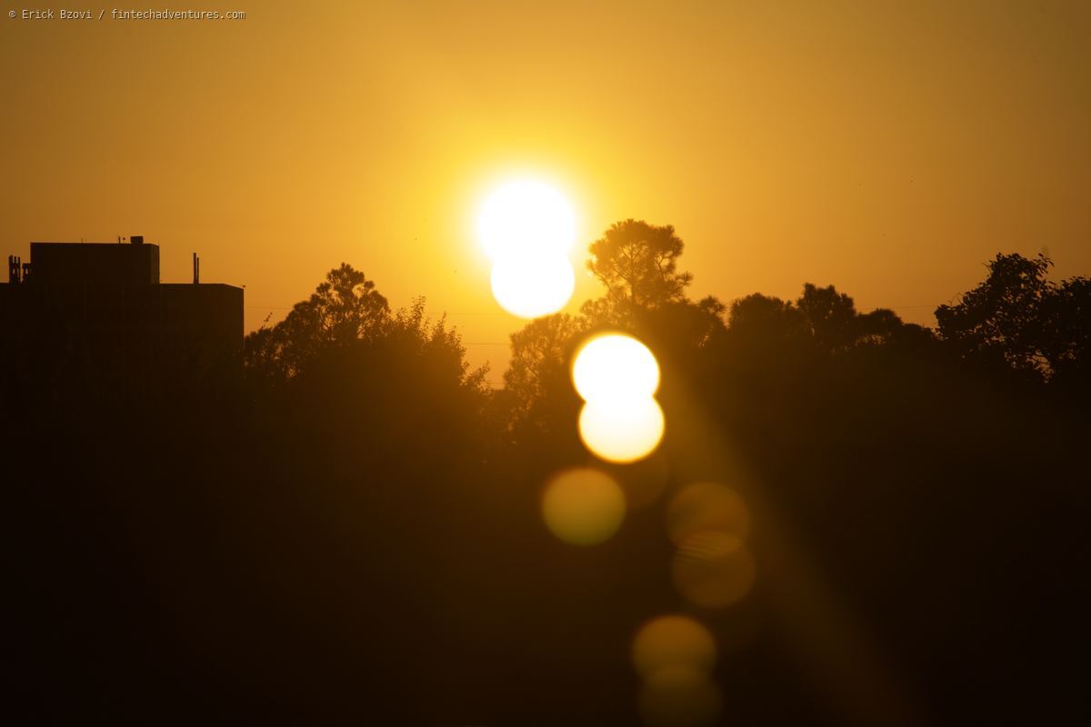 Golden sunset over Oklahoma City with silhouetted trees and skyline