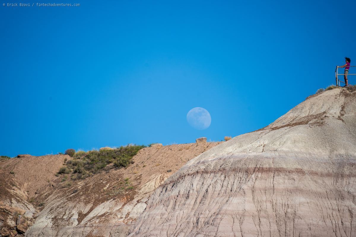 Moonrise over painted desert badlands from the overlook railing at Petrified Forest National Park, Arizona